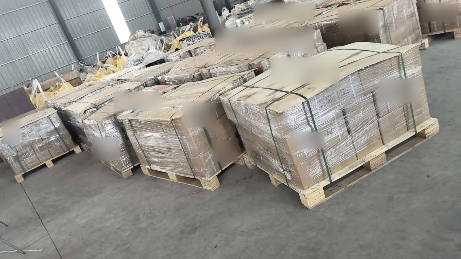 Wrapped and strapped cargo on wooden pallets in a packing area